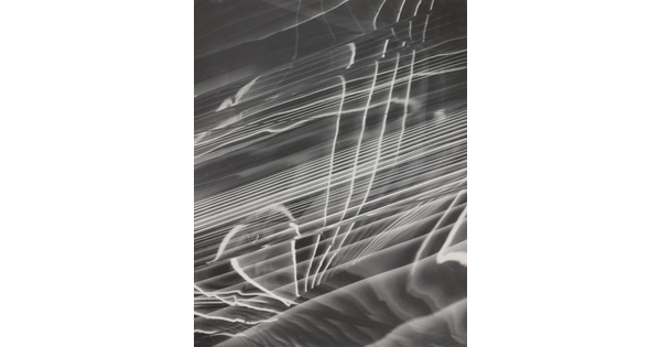A black-and-white photograph of abstract white lines radiating horizontally, layered on top of a rippled background.