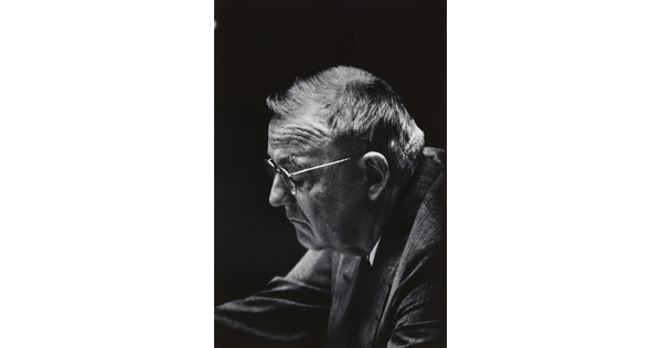 A black-and-white photograph of an older White man wearing glasses, pictured in profile.