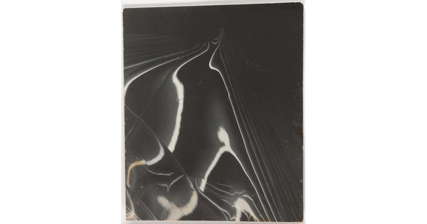 An abstract back-and-white photograph showing bands of light and shadow receding on a mirrored surface.