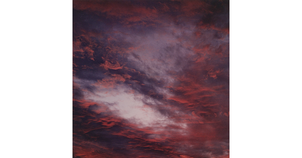 A color photograph of blue, pink, and orange clouds at sunset.