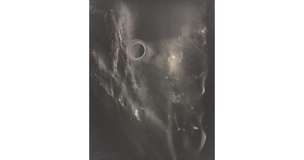 An abstract black-and-white photograph of what resembles a foggy galaxy against a black background.