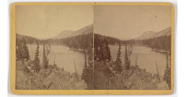 Two almost identical side-by-side sepia-toned photographs of a lake and rocky mountain landscape.
