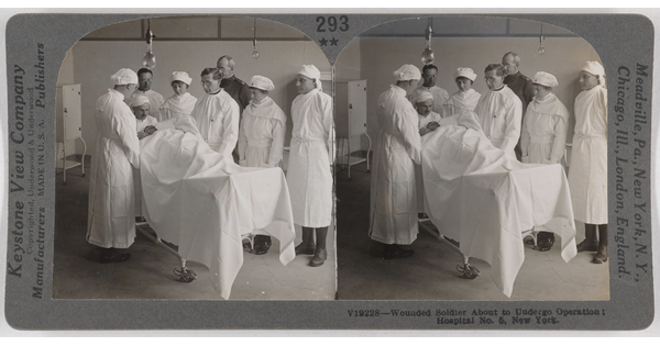 Two almost identical side-by-side black-and-white photographs of men and women in white hospital uniforms surrounding a person lying on a table covered under a white sheet.