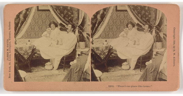 Two almost identical side-by-side sepia-toned photographs of a seated White man in a night gown drinking from a bottle and a White woman holding a baby and sitting on a bed next to him.