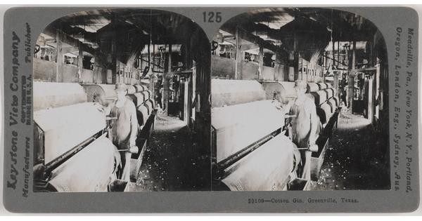 Two almost identical side-by-side black-and-white photographs of a White man standing next to large machinery in a factory.