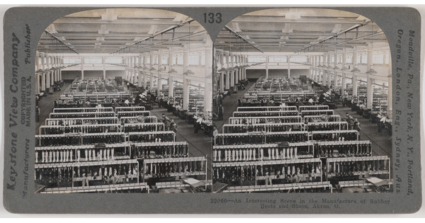 Two almost identical side-by-side black-and-white photographs of the inside of a large factory with rows of frames holding boots and boot molds.