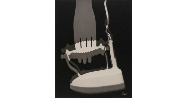 An abstract black-and-white photograph of white and gray silhouettes of what looks like an iron and a fork.