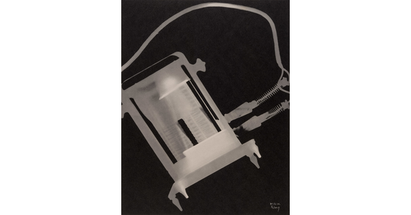 An abstract black-and-white photograph of a white and gray X-ray-like silhouette of a toaster and its electric cords.