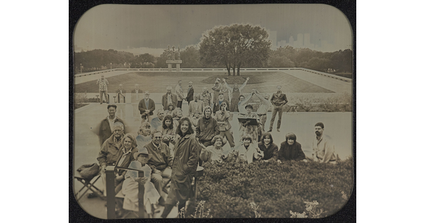 A black-and-white photograph of a group of people posing on the plaza in front of the Carter.