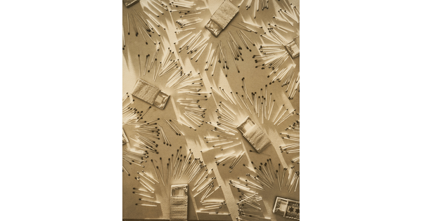 A sepia-toned photograph of wooden matches and opened matchboxes organized in a pattern on a light background.