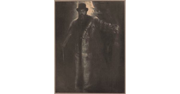 A dark, soft-focus black-and-white photograph of a tall, broad light-skinned man with a beard wearing a top hat and long fur coat.