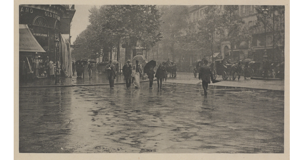 A black-and-white photograph of people crossing a city street in the rain.