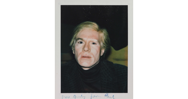 A color snapshot photograph of a White man with blond hair wearing a dark turtleneck.
