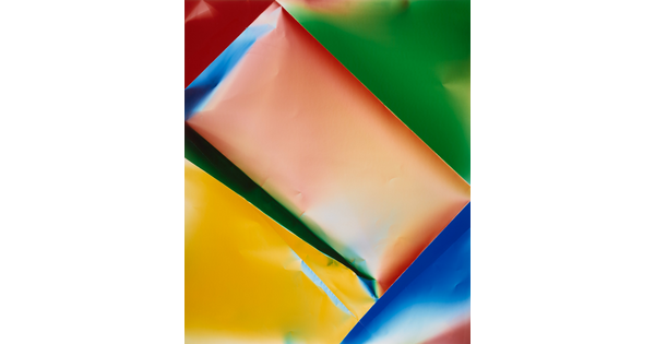 A color photograph of what looks like crinkled paper of orange and yellow rectangles surrounded by a blue, green, and red triangles.