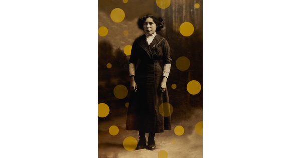 A sepia-toned portrait photograph of an Indigenous woman wearing an ankle-length A-line dress, hair cut short, with yellow dots floating around and behind her figure.