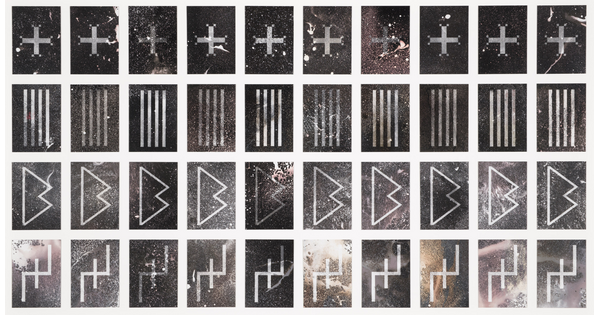 A black-and-white photograph of four rows of 10 symbols: the top row is plus symbols, second is four vertical lines, third looks like a pointed capital B, the fourth row looks like a plus sign with vertical lines coming off of its horizontal bar.