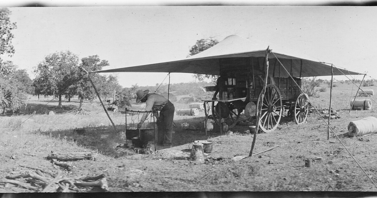 The LS cook [Sam Whittaker] prepares the noonday meal for the cowboys ...